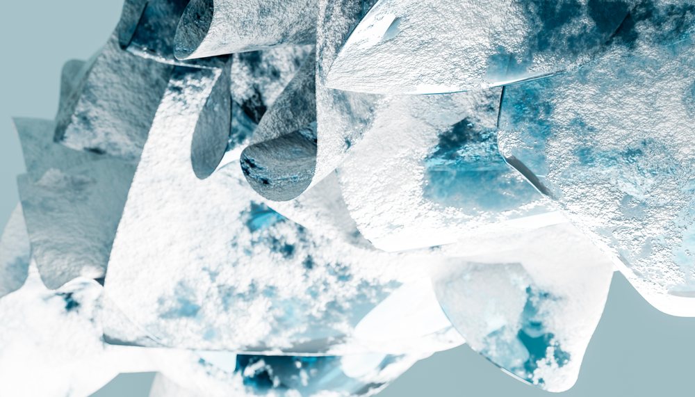 Close-up view of irregular metal shards with frosted icy texture and blue reflections on rough surfaces.