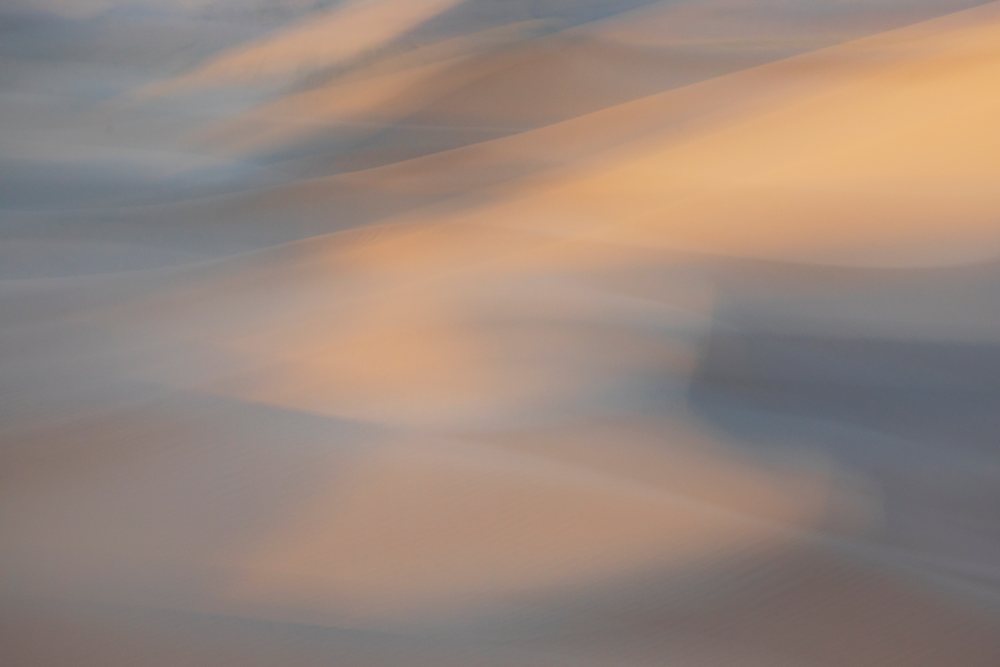 Sunlight and shadows create abstract patterns on smooth sand dunes in the Erg Lehoudi desert, Lifestyle, Landscape, Culture, M'Hamid, Zagora Province, Morocco.