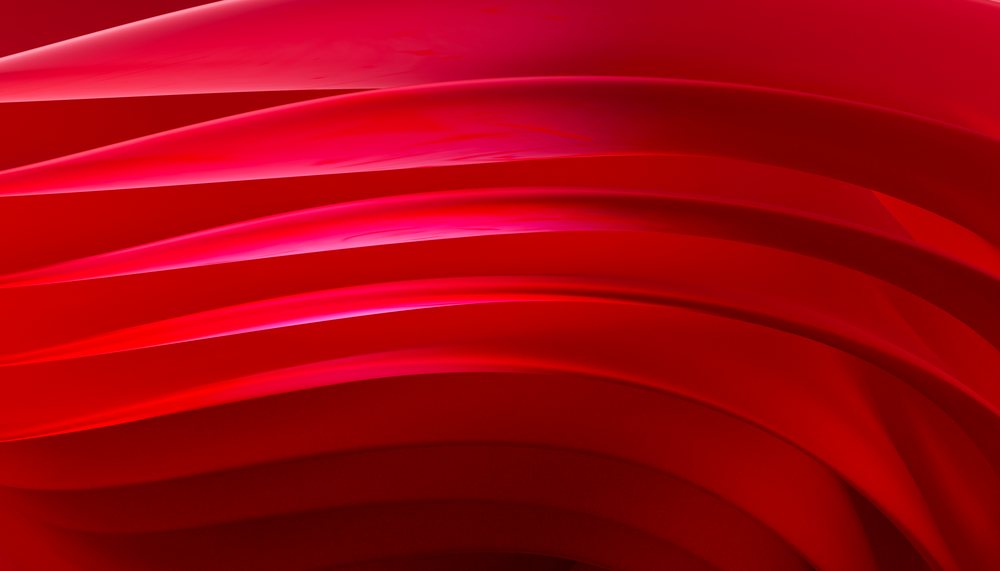 Close-up of flowing red fabric with curved layers forming abstract