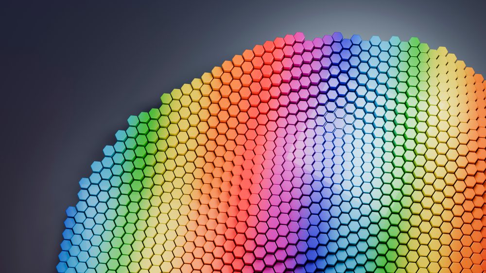 Digital 3D illustration of hexagonal tiles arranged in a curved honeycomb pattern with a vibrant rainbow color gradient.