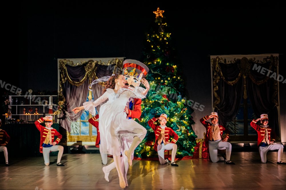 Ballerina dances with wooden soldier on stage