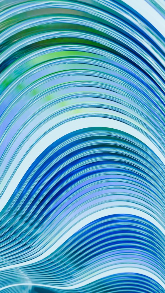 Abstract digital illustration of smooth flowing blue and green curved wavy lines forming a dynamic striped pattern.