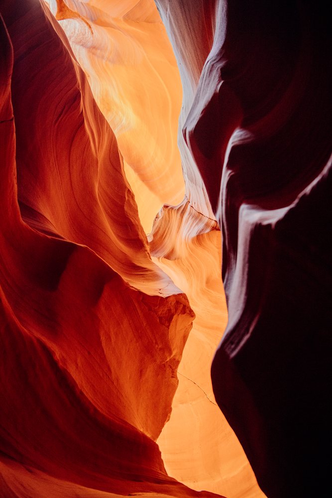 Sunlight illuminates the curving sandstone walls of Antelope Canyon, Navajo Land, Arizona, USA.