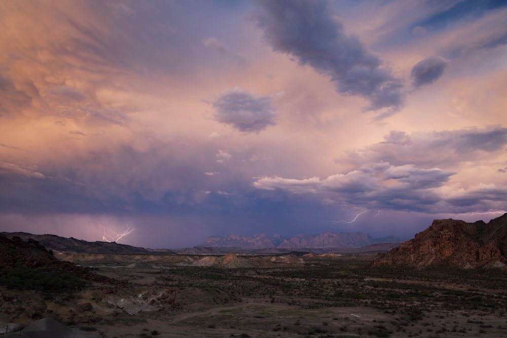 Lightning strikes illuminate the Chisos Mountains during a stormy sunset, Landscape, Wildlife, Big Bend National Park, Texas, USA.