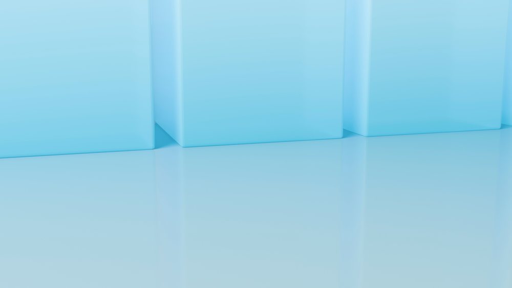 Three blue cubes rest on a reflective smooth surface in a minimalistic geometric setting with soft lighting.