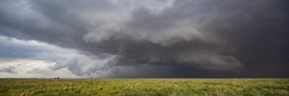 Supercell storm with dramatic dark clouds forming over open grassland, in Tornado Alley, Morton, Texas, USA.