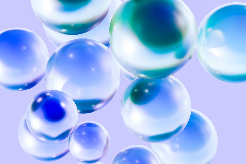 Blue and white transparent spheres with reflections float against a purple abstract background.