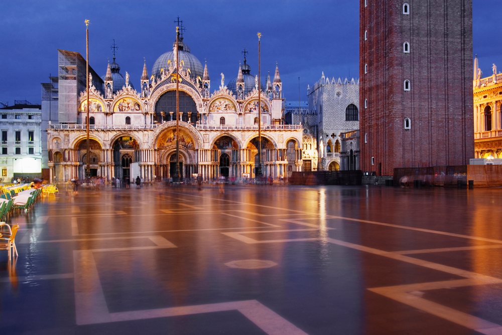 St Mark's Square in Venice illuminated at night with San Marco Basilica and the bell tower visible, Veneto, Italy.