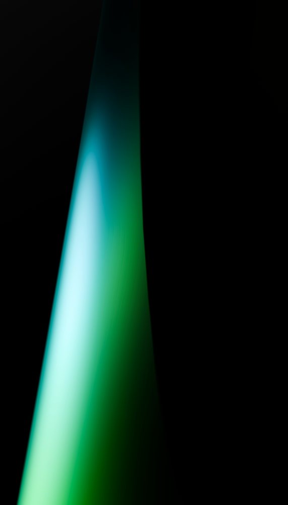 Green and blue gradient light beam on a dark background creating an abstract lighting effect.