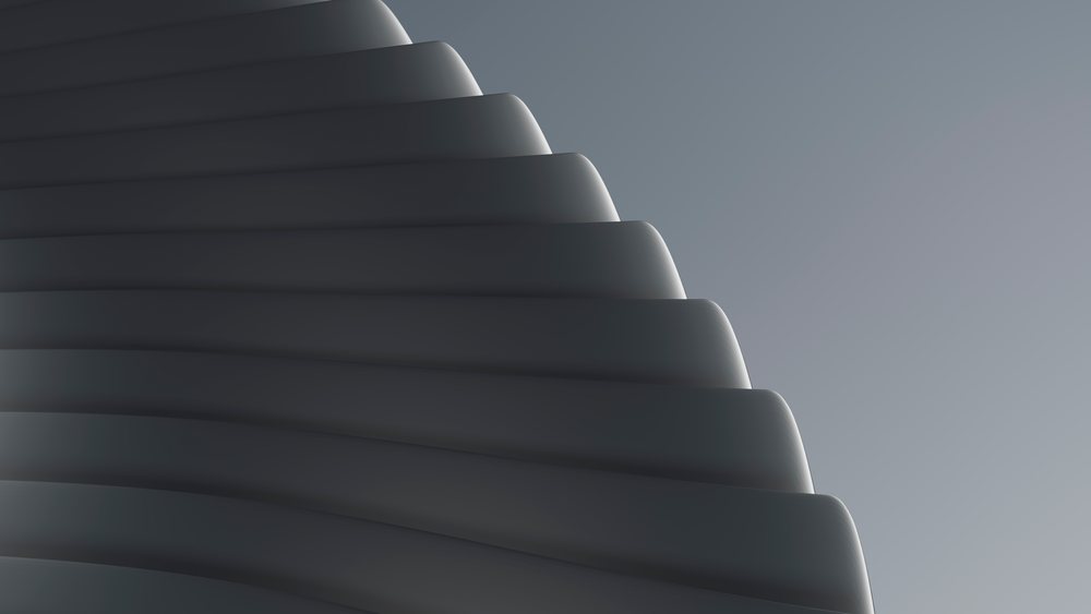 Smooth dark curved shapes overlap against a gradient background in a minimalist modern abstract design.