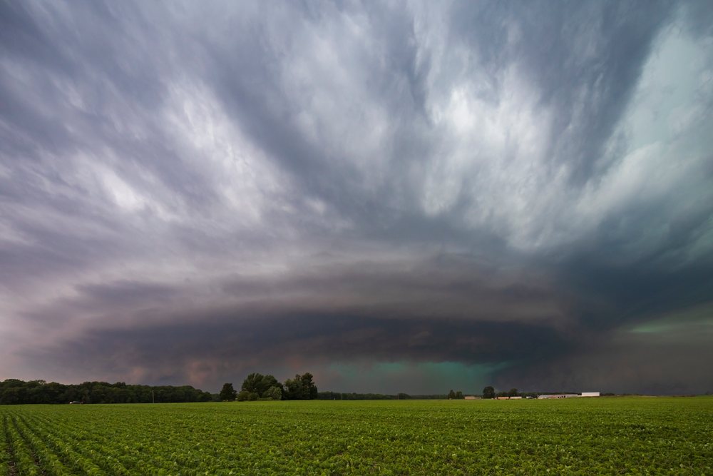 Large Cyclic Supercell storm cloud forms over a green agricultural field, Illinois, in Tornado Alley, Weather, Environmental Issues, Storm Chasing, Charleston, USA.