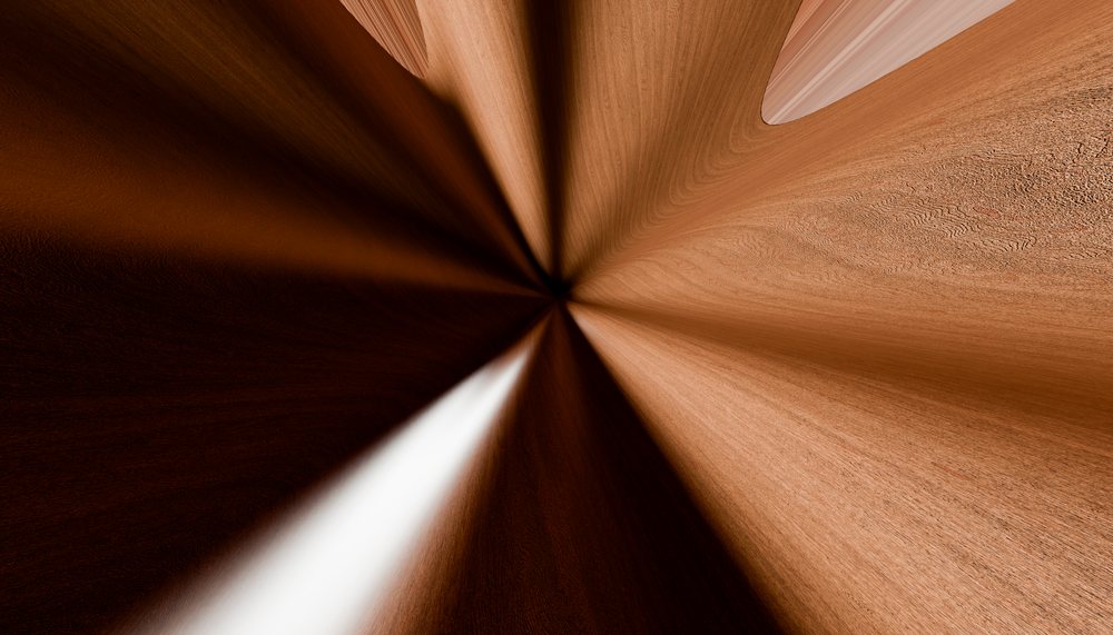 Radial wood texture pattern with natural grain and varying brown tones creating an abstract symmetrical design.