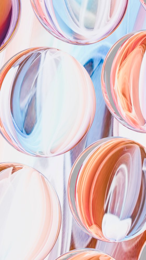 Digital abstract illustration of colorful transparent glass spheres with smooth, shiny surfaces and multiple reflections.
