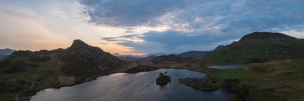 Cregennan Lakes at sunset, showing a peaceful mountainous landscape and a small island in the lake, Wales, Dolgellau, Gwynedd, Waleds.