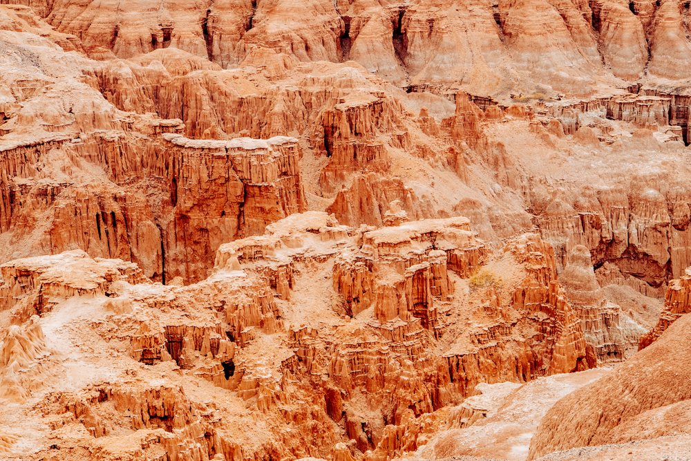 Sandstone rock formations and cliffs displaying erosion dominate the arid desert landscape of Cathedral Gorge State Park, Nevada, USA.