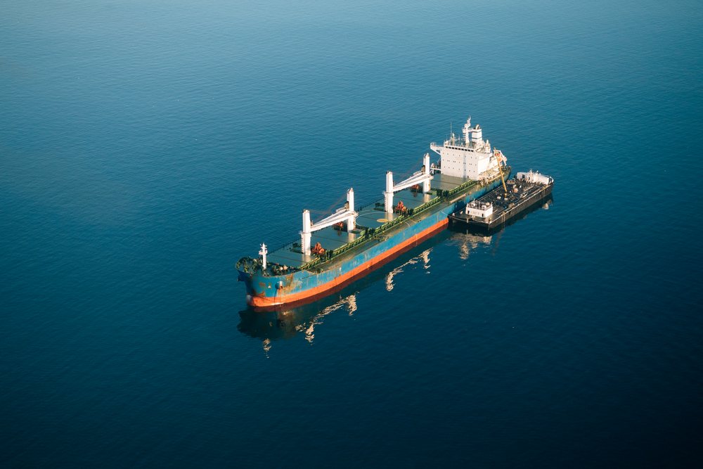 Cargo ship being refueled by a tanker vessel at the, Port of Long Beach, CA, USA.