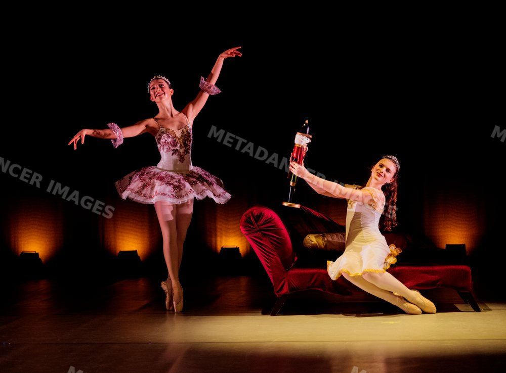 Two ballet dancers perform a holiday ballet scene on stage