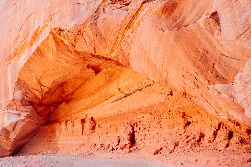 Buckskin Gulch slot canyon, showing red sandstone walls and natural rock formations under sunlight, Utah, USA.