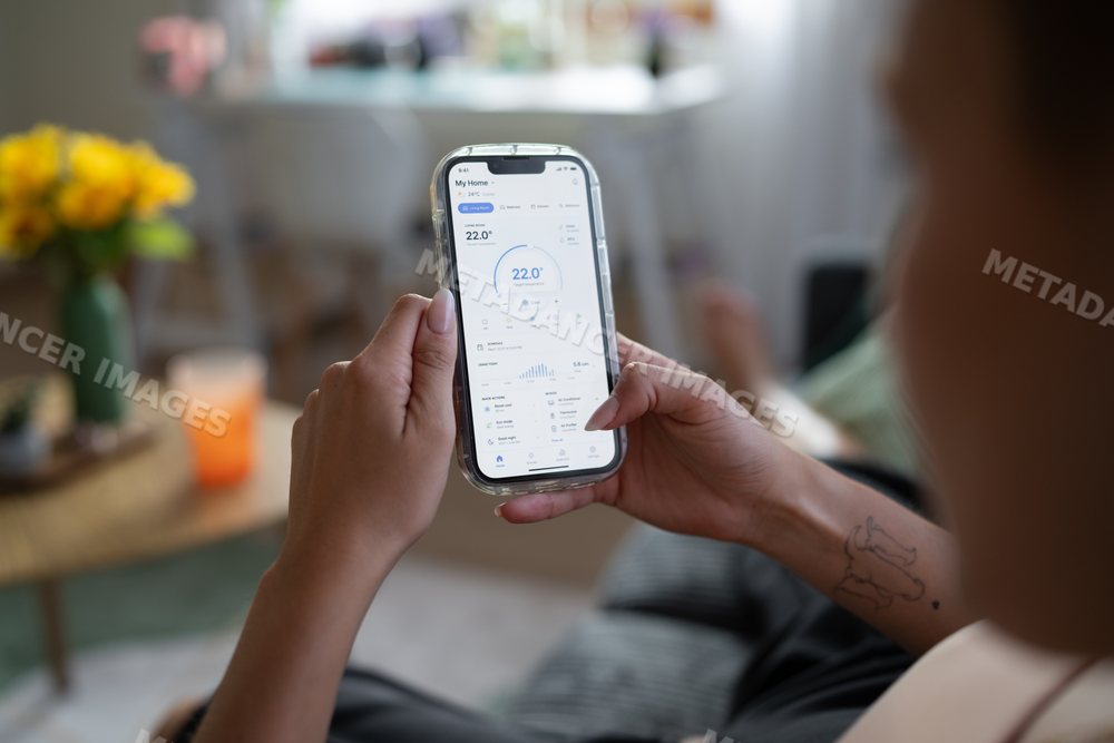 White Person adjusts temperature on smart home thermostat application