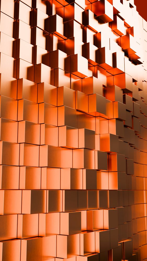 Orange metallic 3D cubes create an abstract geometric pattern with a shiny, reflective surface.