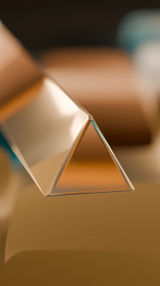 Transparent triangular glass prism showing optics and light refraction