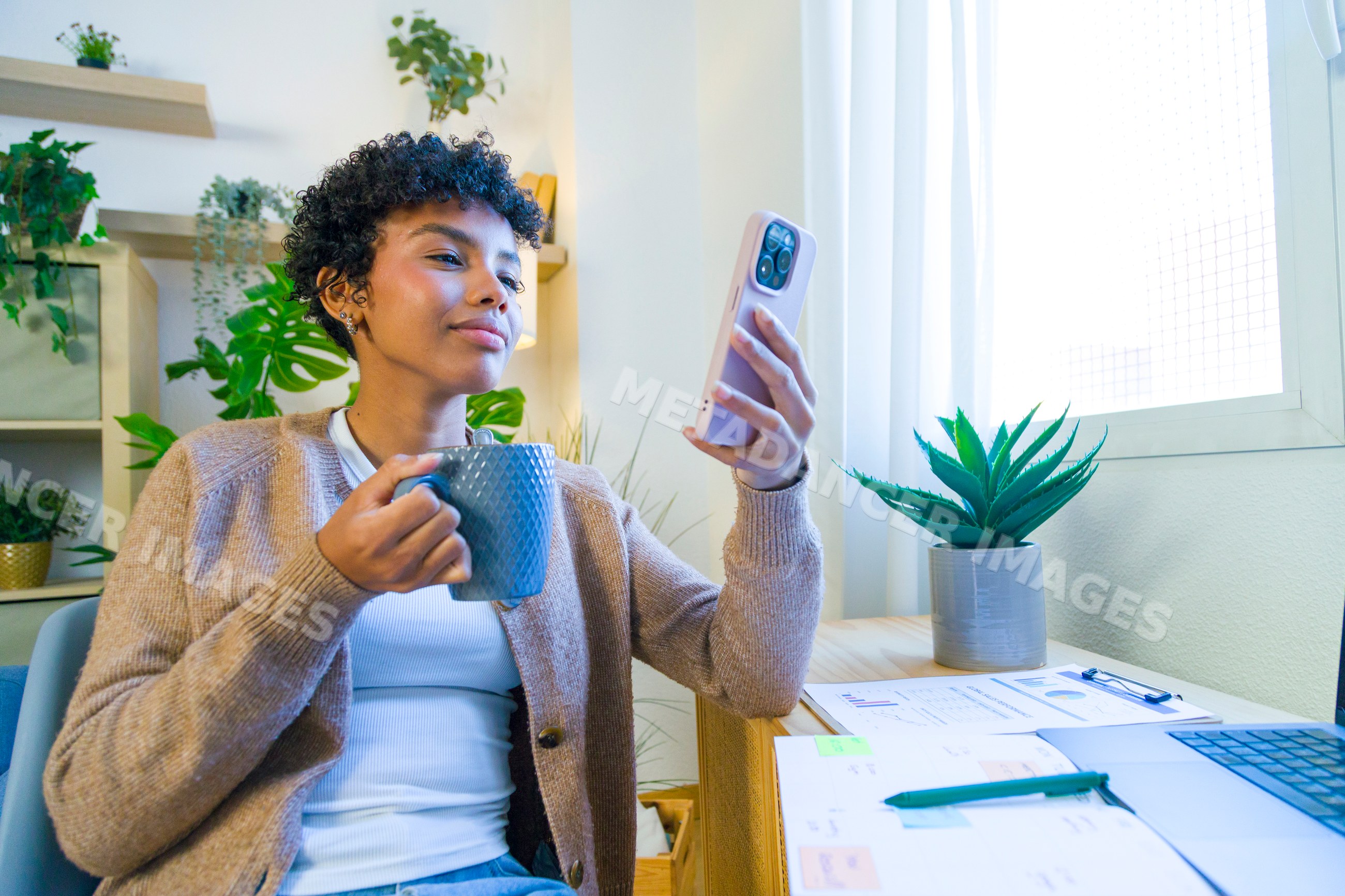 African American woman holding mug looking