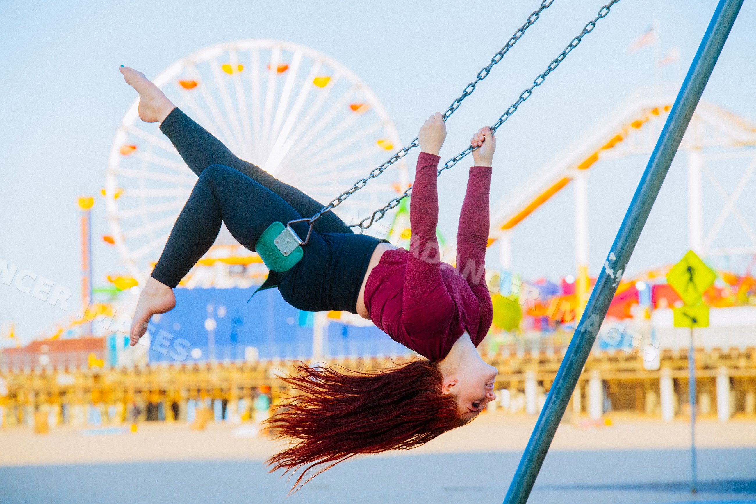 White woman swinging upside down