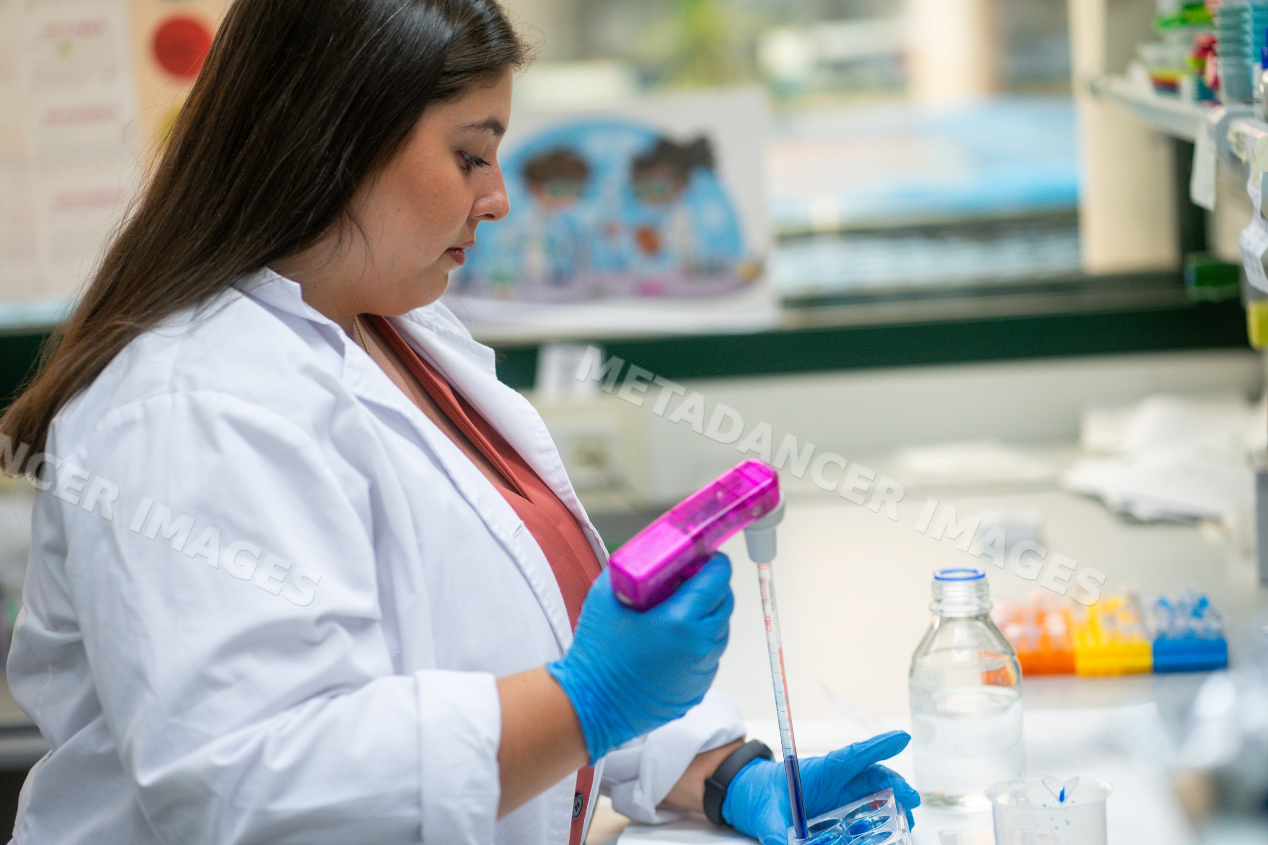 Scientist transferring liquid with pipette