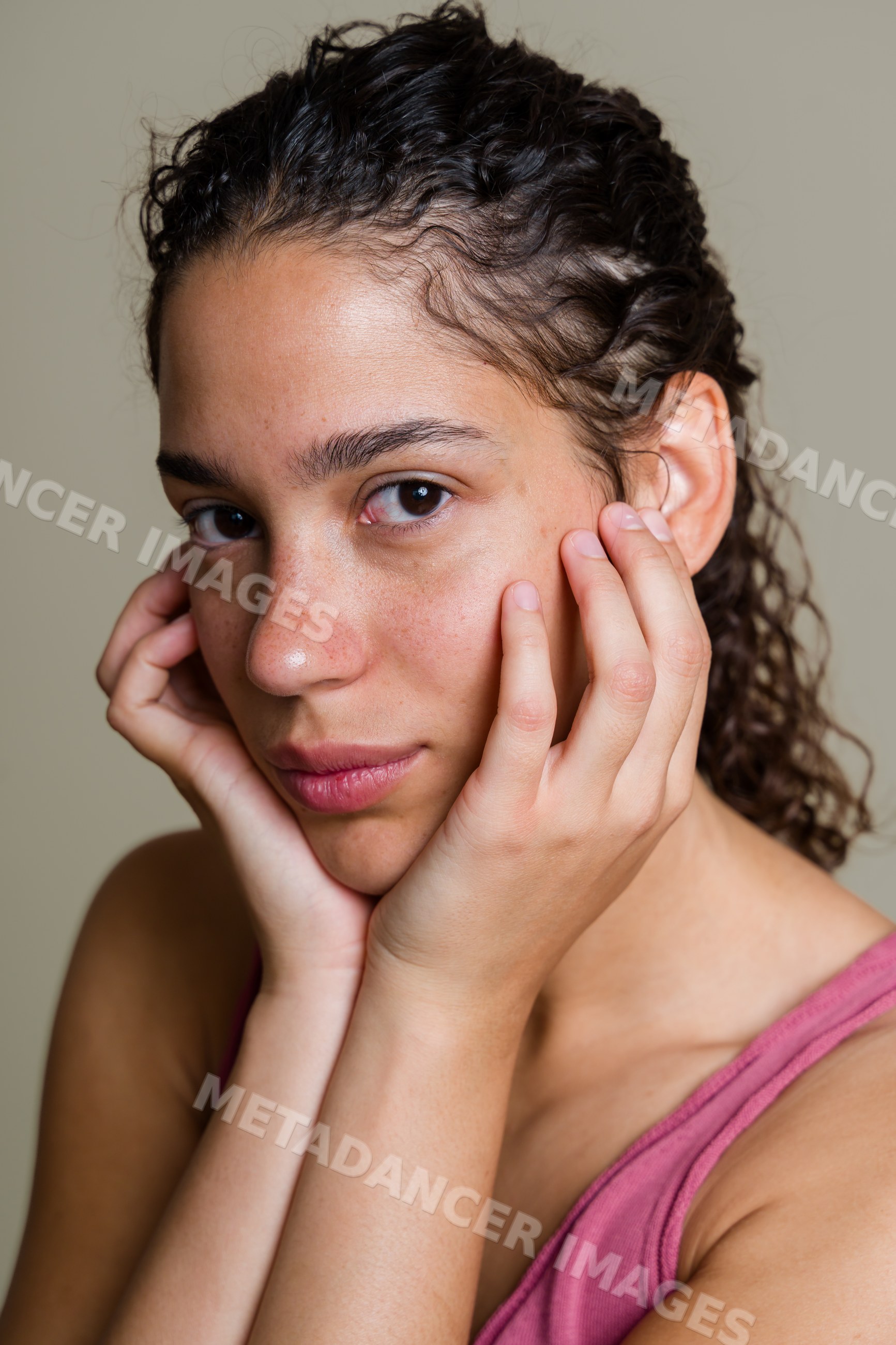 Portrait of Hispanic woman resting her face