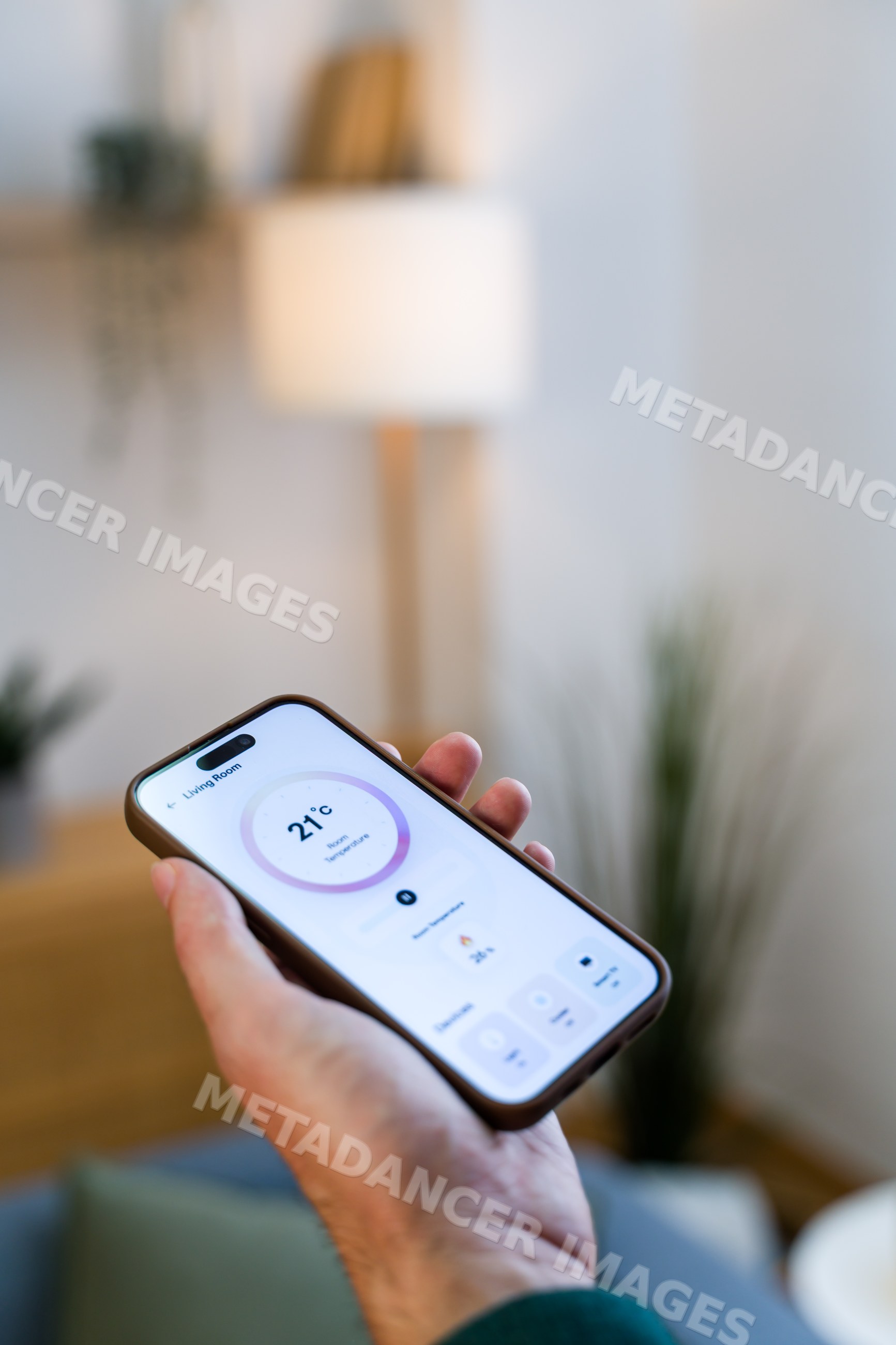 Smartphone showing living room temperature control smart home app