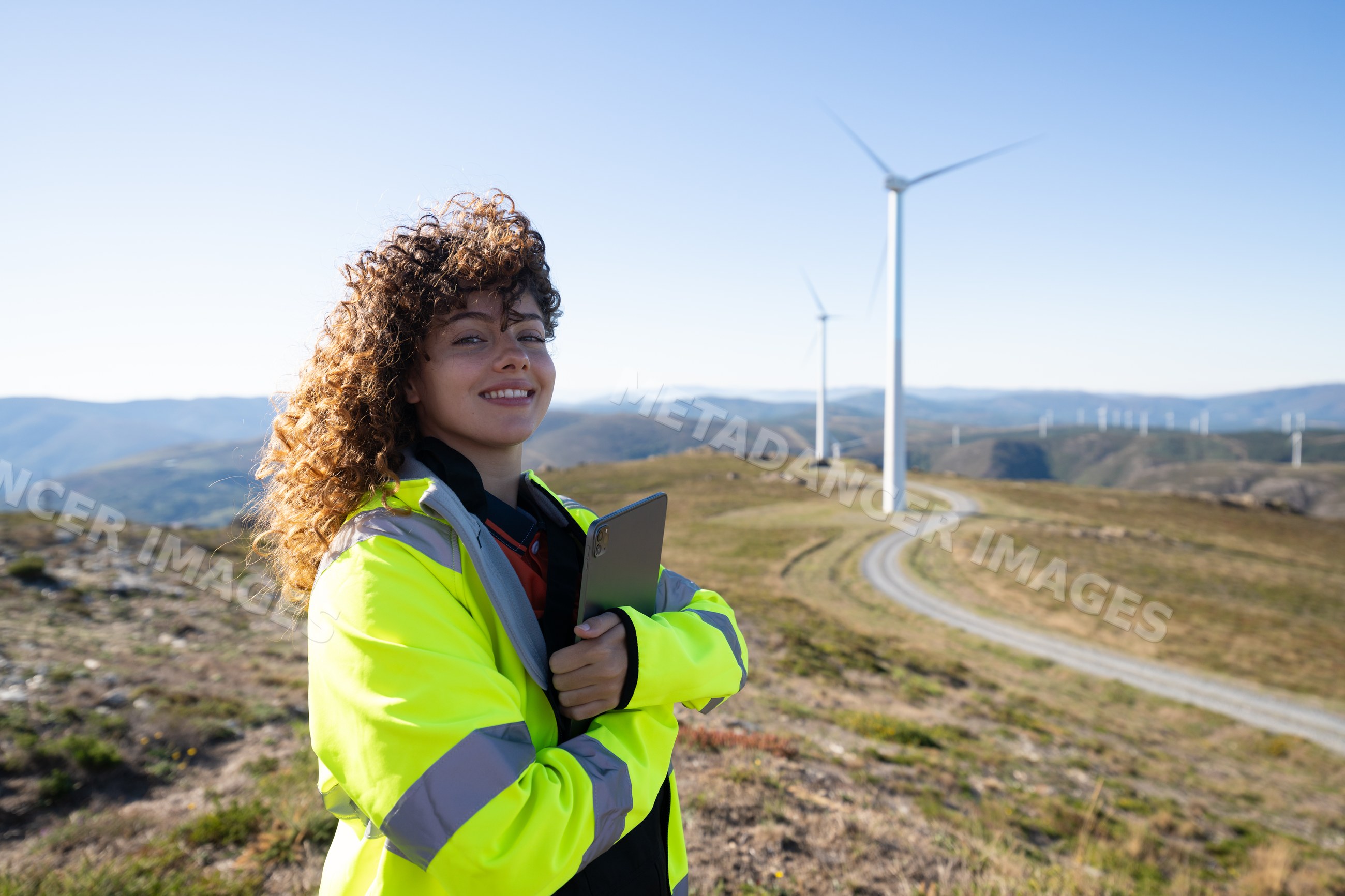 White woman with tablet at wind farm in Galicia Spain