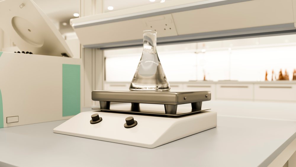 Laboratory flask on magnetic stirrer in laboratory environment
