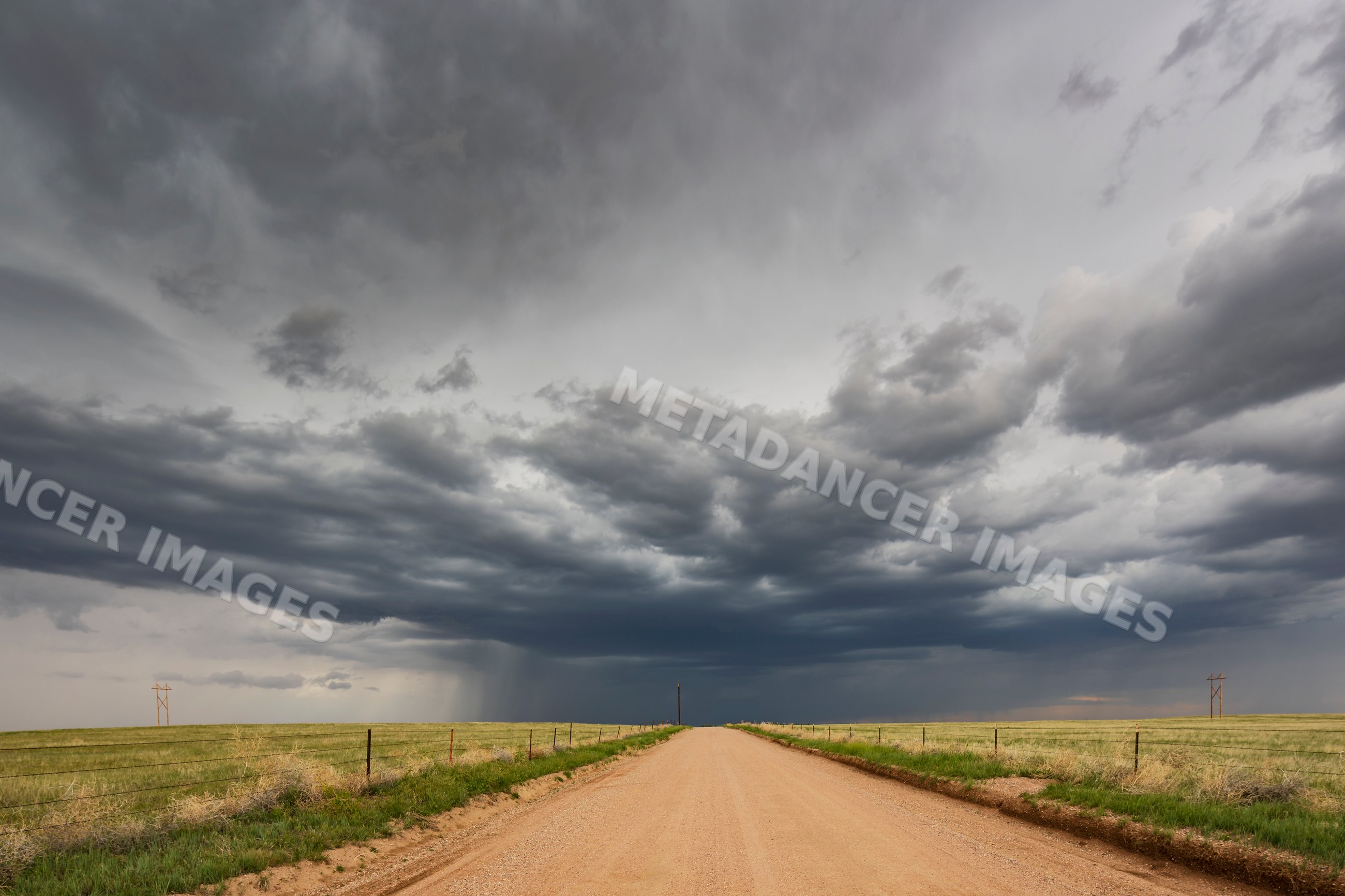 Developing Supercell storm over dirt road in wyoming grasslands