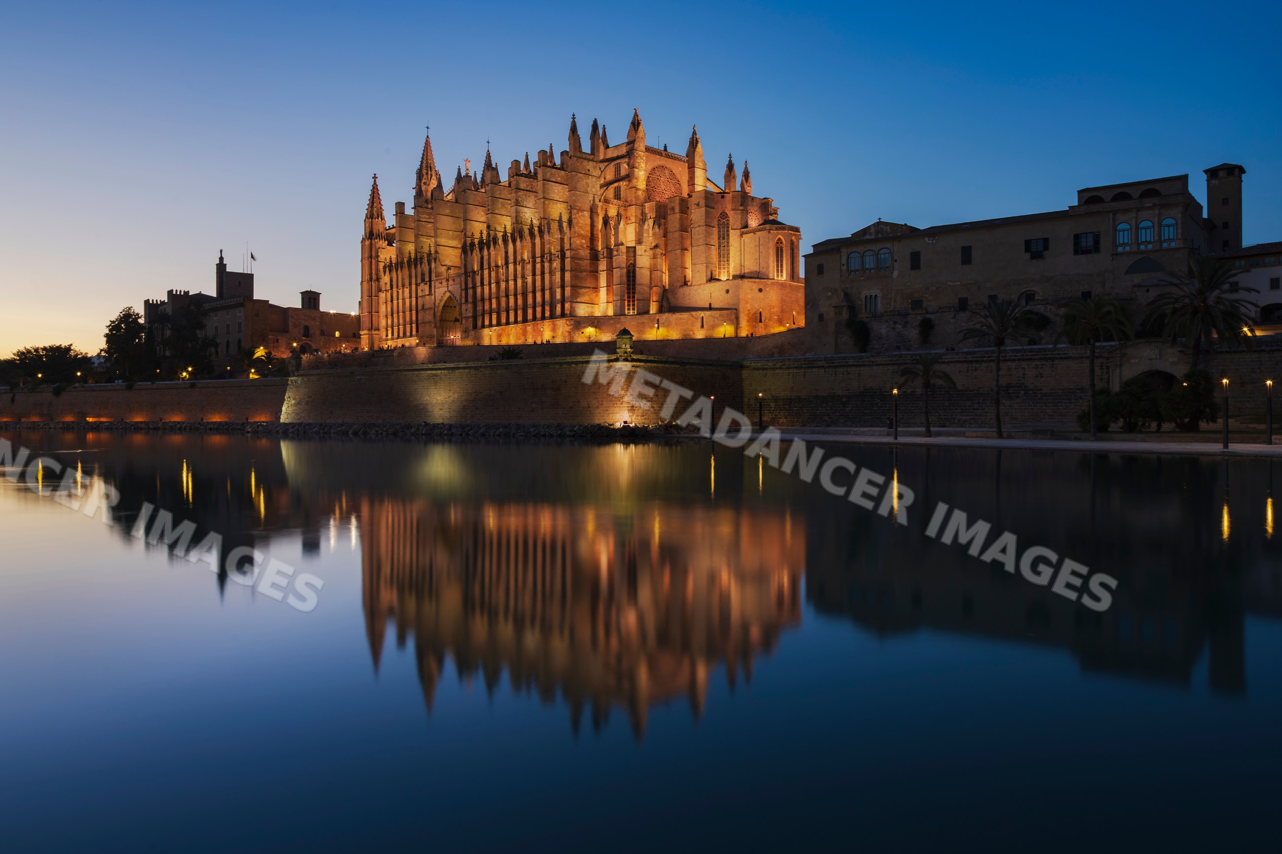 Mallorca cathedral illuminated at Dusk with water reflection