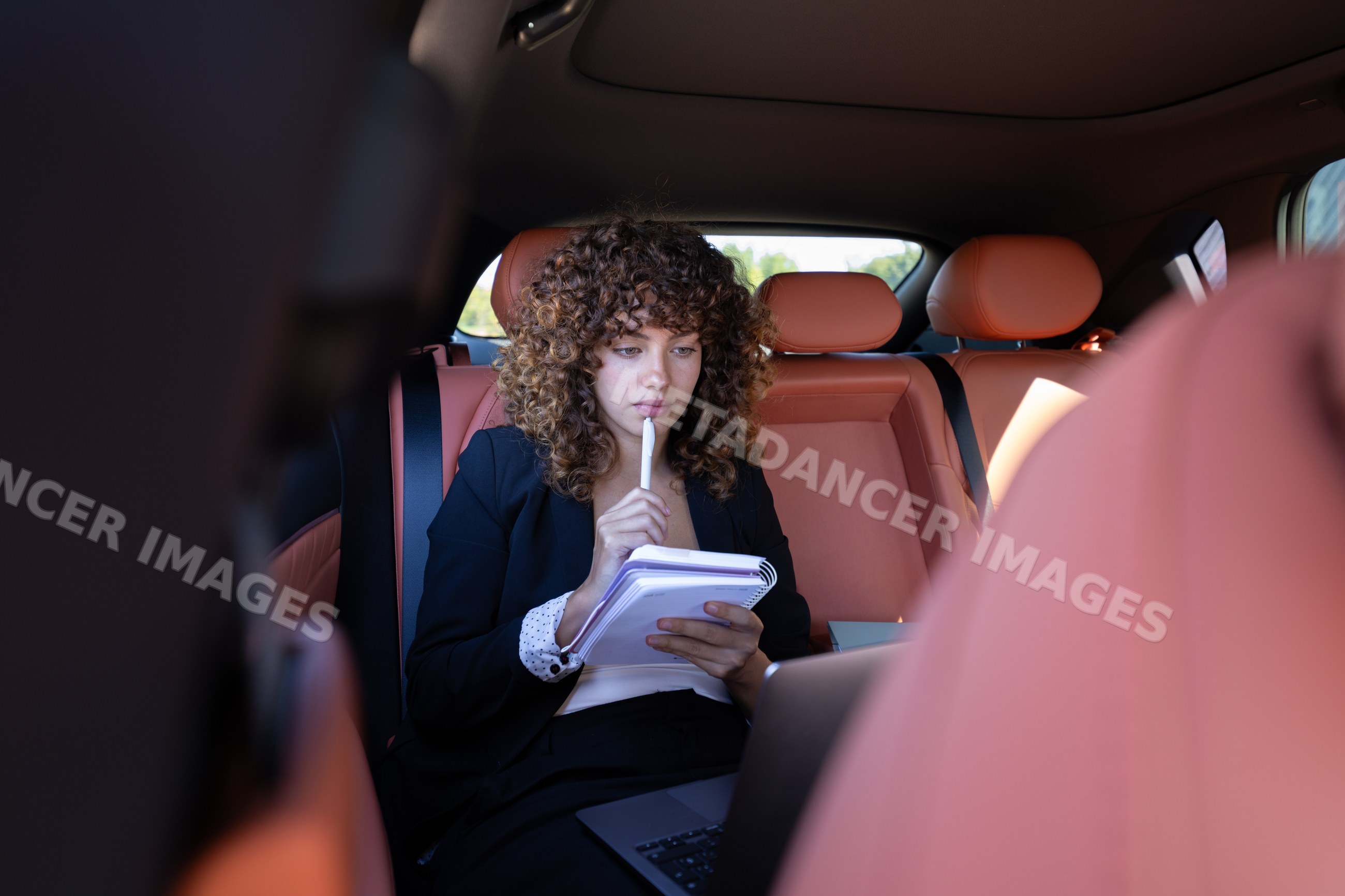 Businesswoman working remotely inside car in Spain