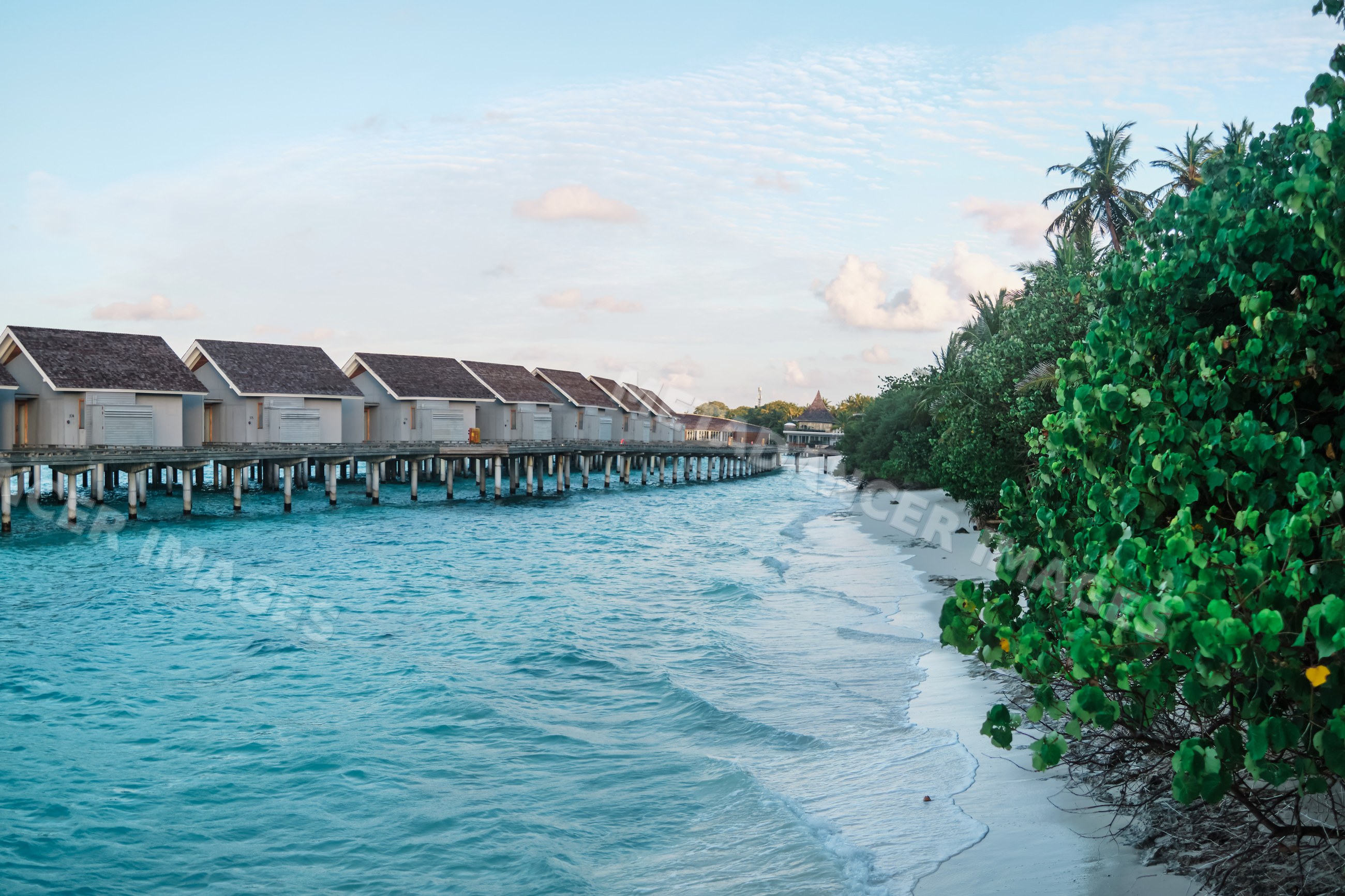 Water villas over turquoise ocean water