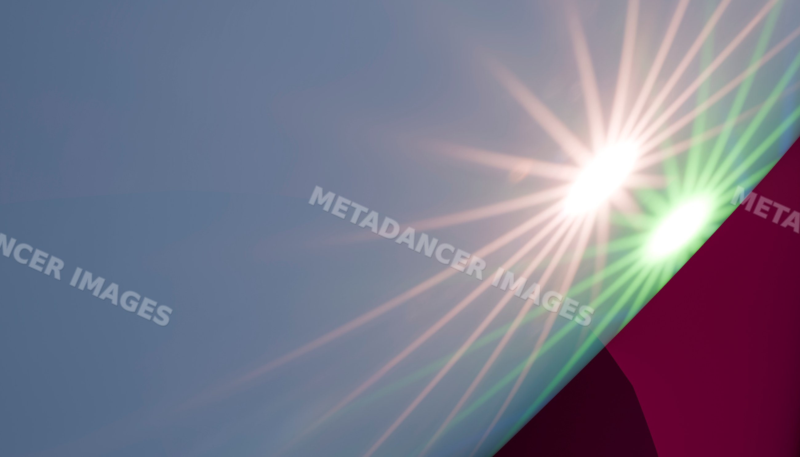 Bright sun flare with lens flare and light beams in a clear sky
