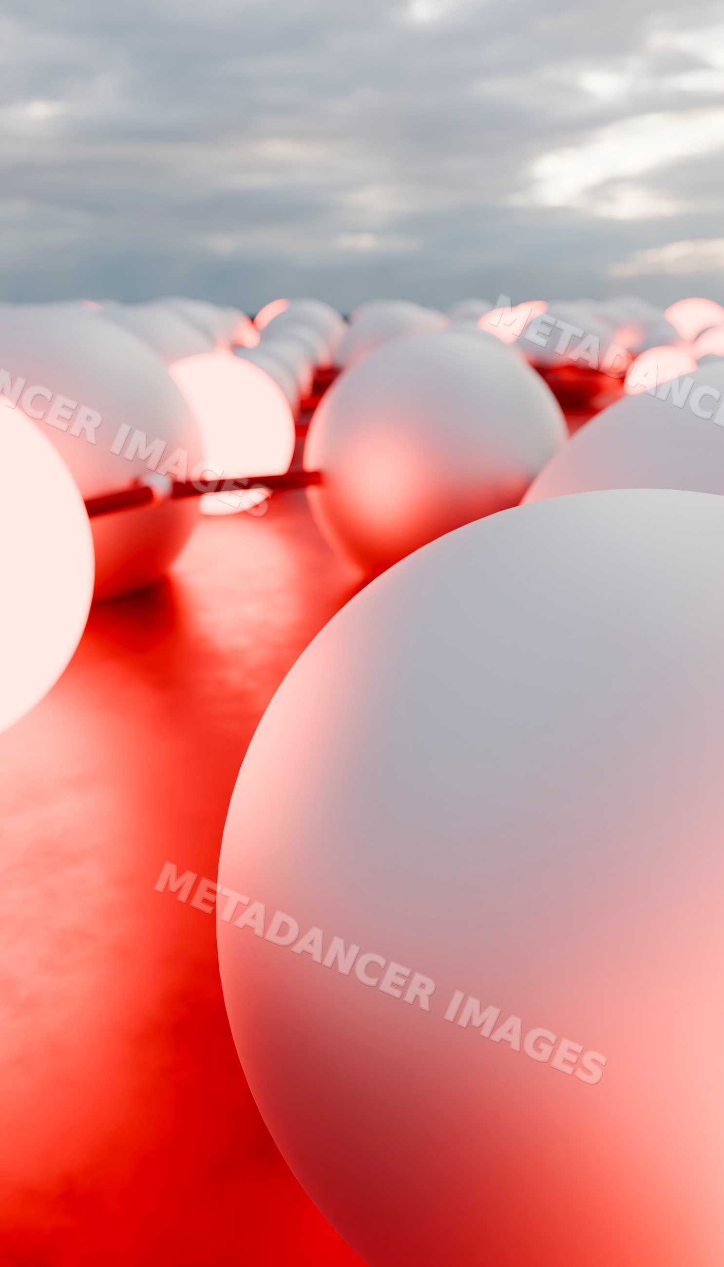 Close-up view of white spheres illuminated by red lighting
