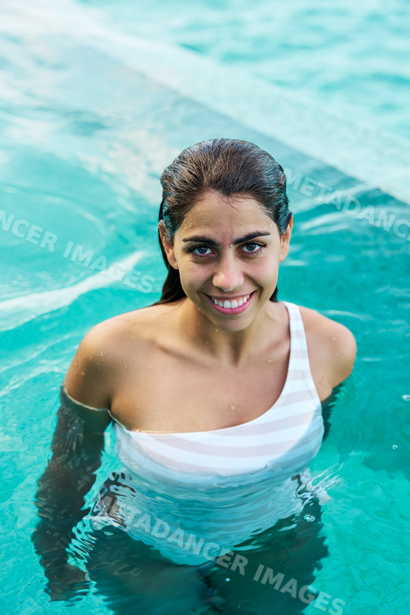 White Woman smiling in a swimming pool