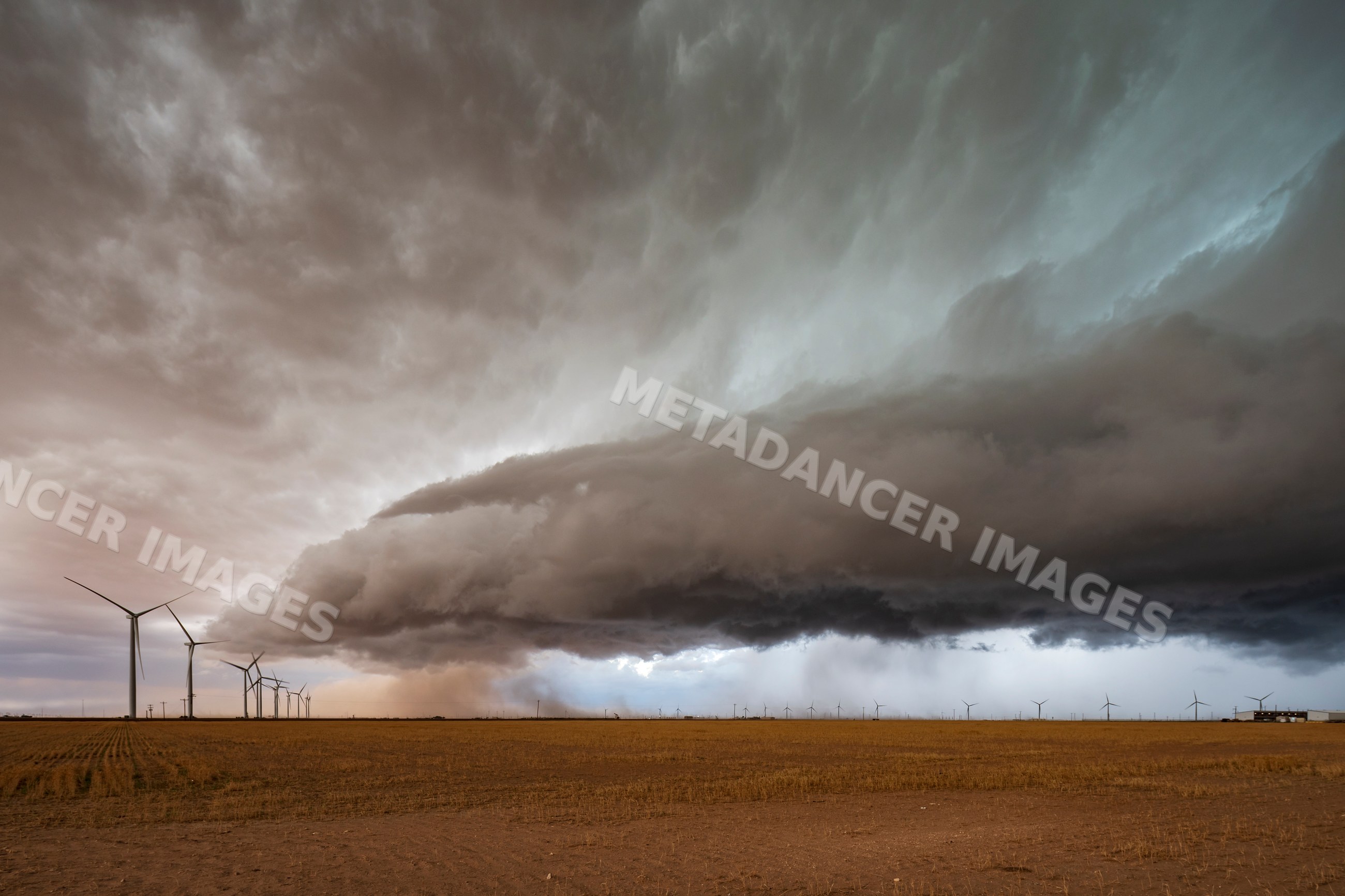 Supercell storm over wind farm in garden city texas Great Plains