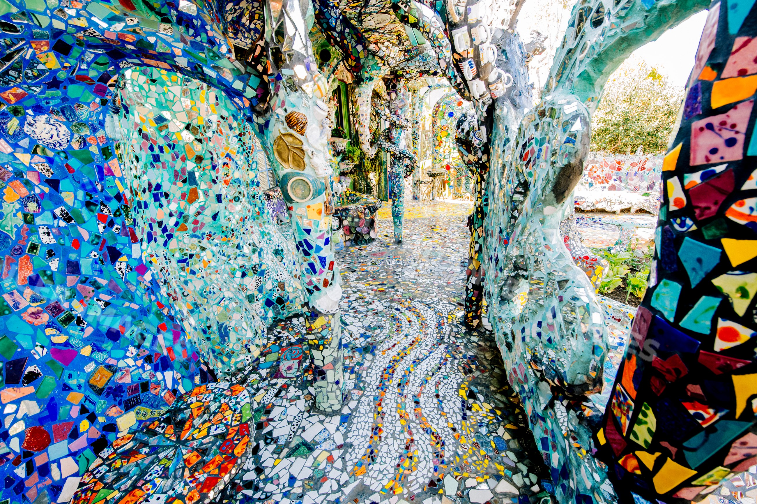 Colorful mosaic tiled outdoor walkway and benches with artistic
