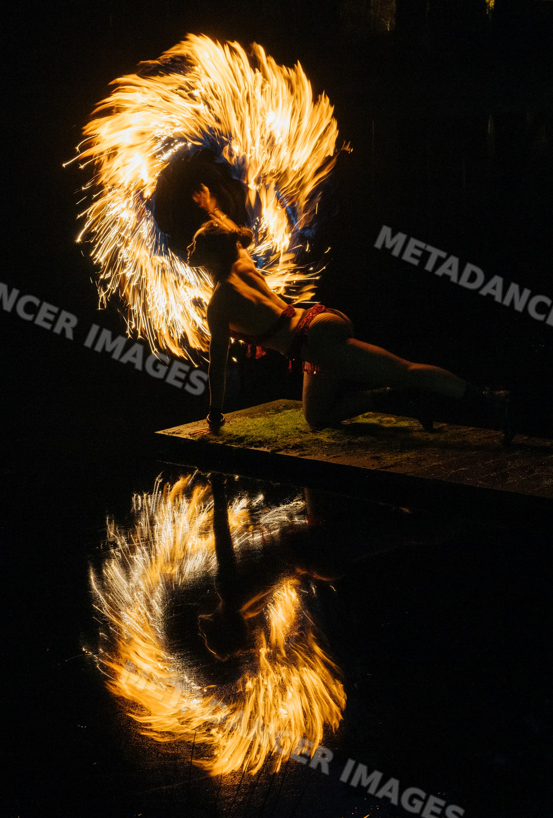 Fire African American performer spinning flaming fire