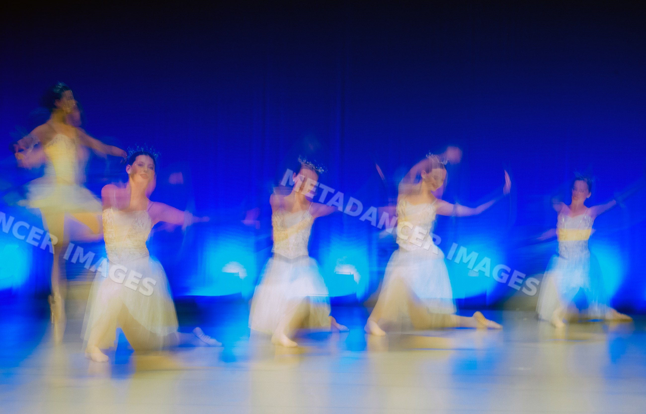Ballet dancers perform a blurred movement routine