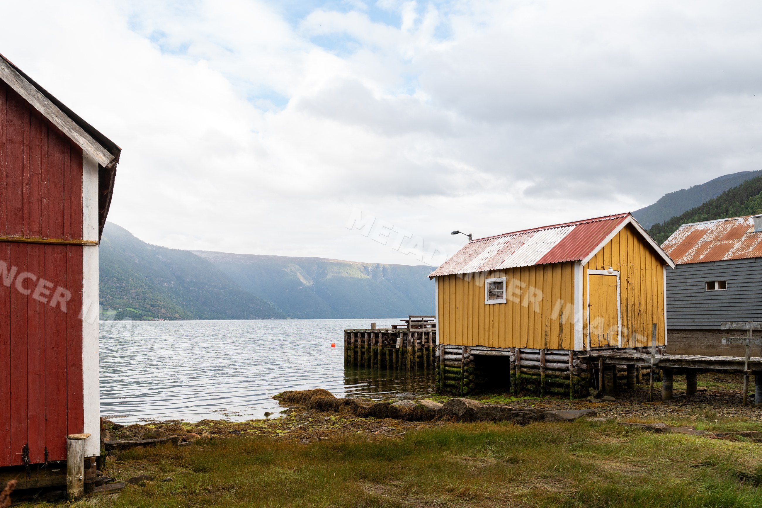 Boathouses on wooden stilts by a Fjord in Luster, Norway