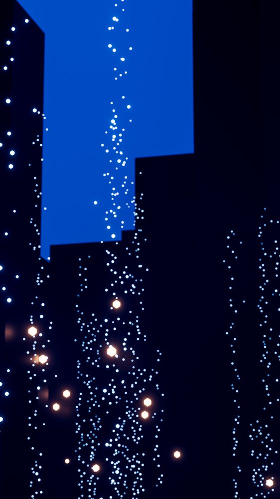 Blue and orange glowing particles float in dark abstract digital scene