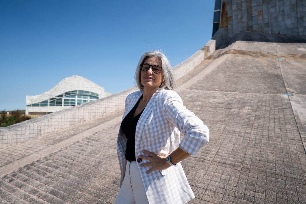 Businesswoman with gray hair wearing plaid blazer outdoors