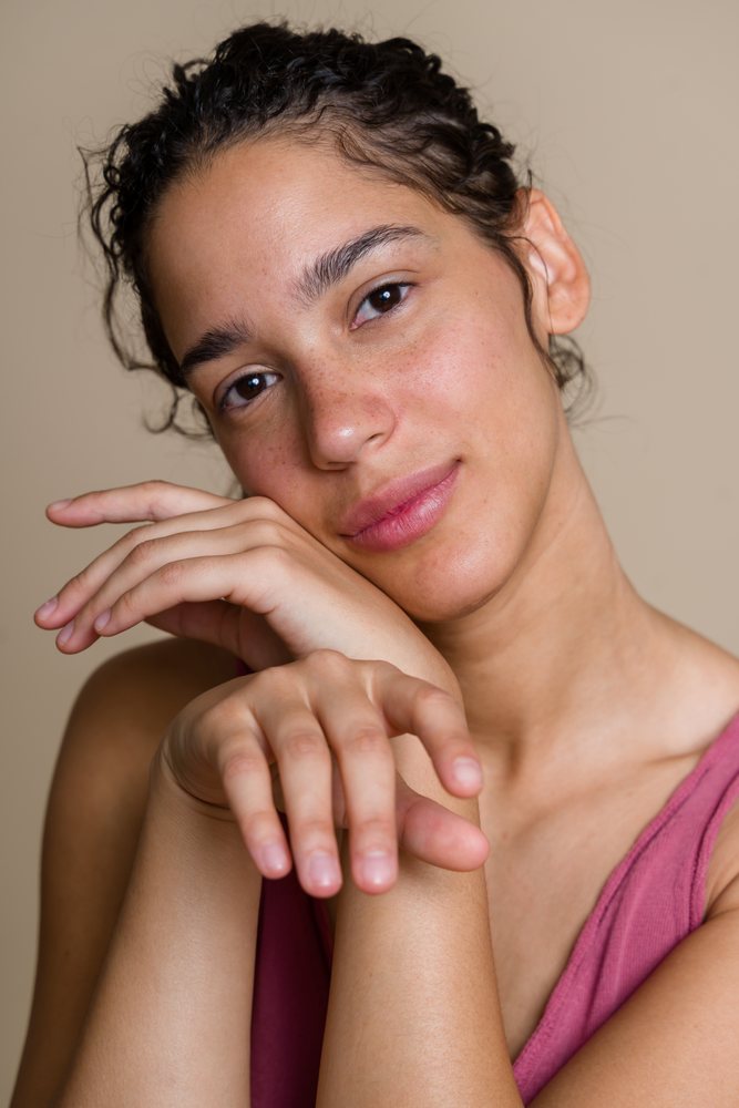 Portrait of Hispanic woman with natural skin posing with hands