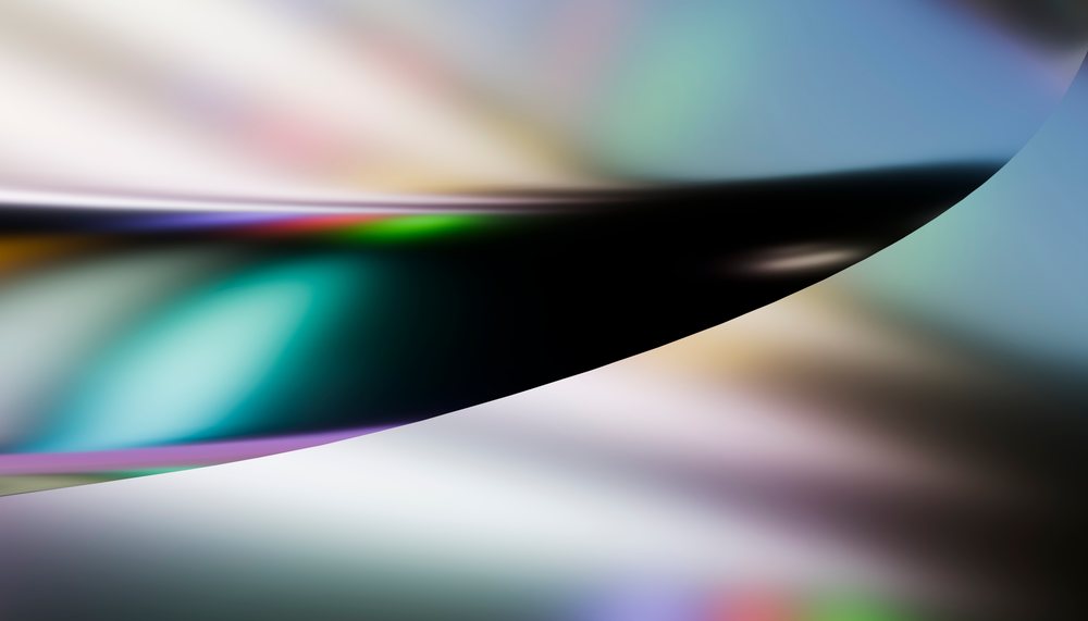 Abstract close-up of a curved shiny surface with colorful light