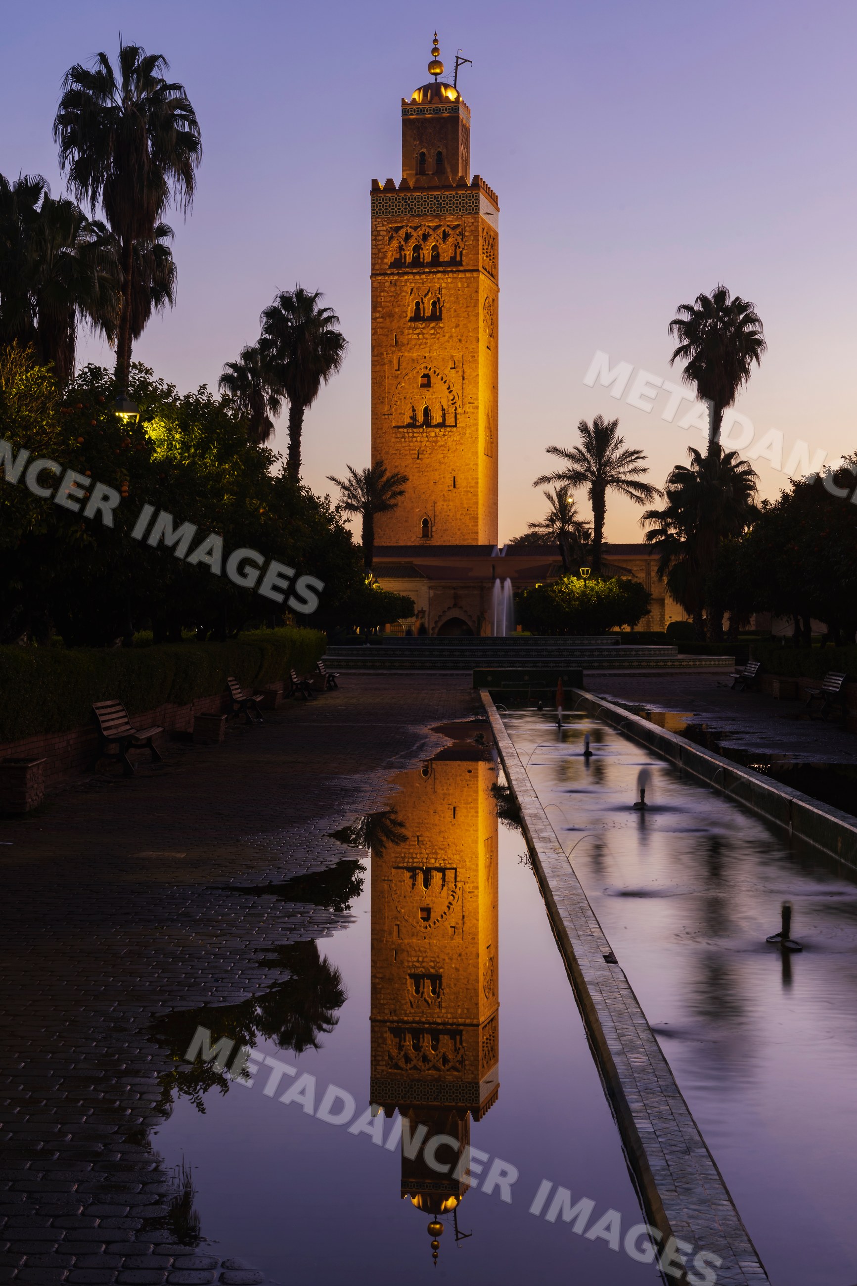 Koutoubia minaret reflected in a puddle at Dawn in marrakech