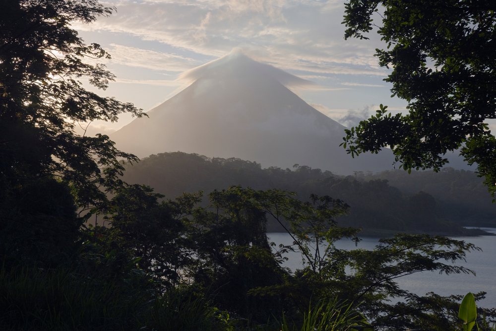 Arenal volcano at dawn with mist and lake, costa rica